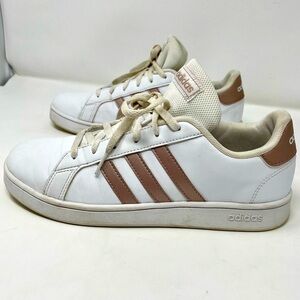 Women’s leather and rose gold Adidas tennis trainers.
